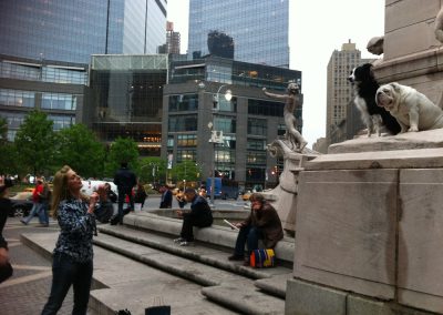 Cheryl taking a picture of 2 dogs, Gabe and Nana, and a statue